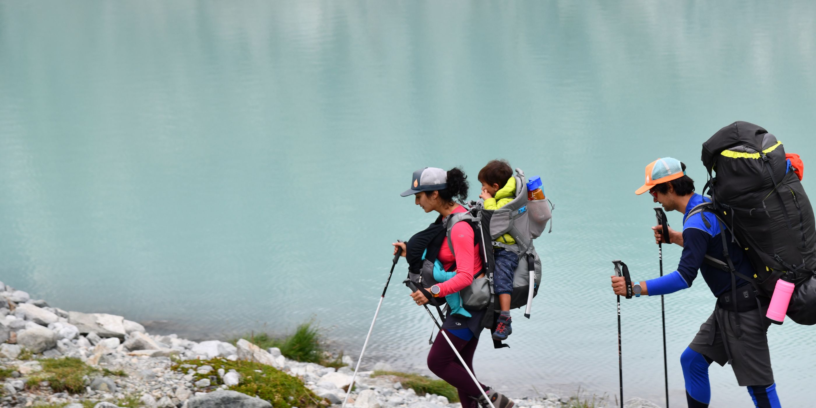 Family hiking next to lake